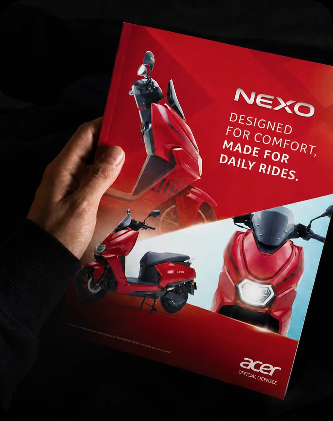 Printed NEXO electric scooter brochure for Acer held in low light