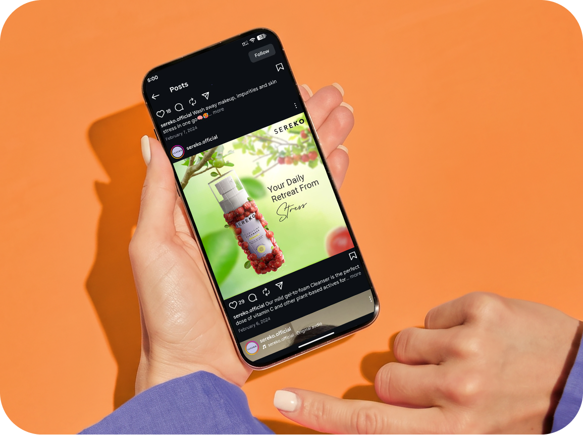 Sereko “Your Daily Retreat From Stress” Instagram post open on a phone held over an orange backdrop