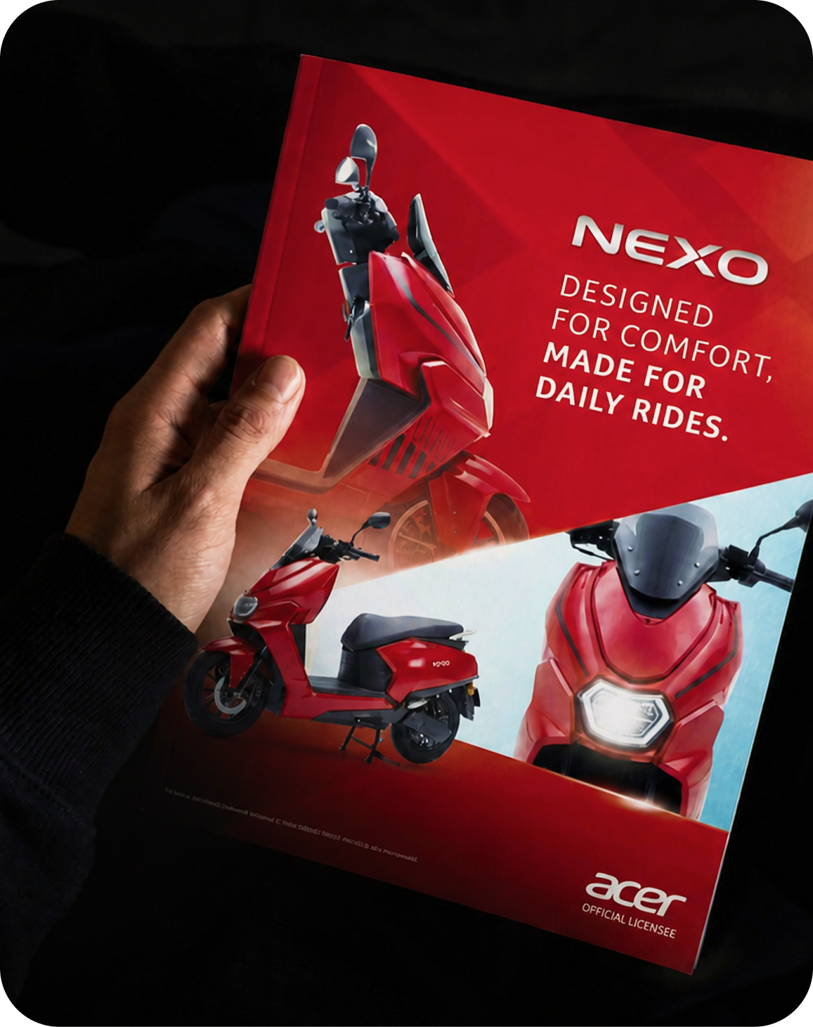 Printed NEXO electric scooter brochure for Acer held in low light